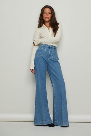 Mid Blue Jean 70’s large avec poche sur le devant