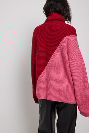 Red/Pink Pull effet color block en maille en biais