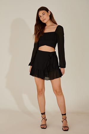 Black Mini jupe asymétrique à volants en matière recyclée